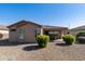 Home exterior showcasing the beautiful backyard with colorful flowering shrubs and desert landscaping at 4245 E Ficus Way, Gilbert, AZ 85298