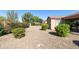 Spacious backyard featuring desert landscaping with gravel, colorful flowering plants, and a patio at 4245 E Ficus Way, Gilbert, AZ 85298