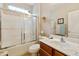 Well-lit bathroom with shower-tub combo and wood vanity with framed mirror at 4245 E Ficus Way, Gilbert, AZ 85298