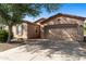 Inviting single-level home featuring a two-car garage and low-maintenance desert landscaping at 4245 E Ficus Way, Gilbert, AZ 85298