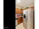A stainless steel refrigerator complements the cabinetry and granite countertops in this delightful kitchen at 4245 E Ficus Way, Gilbert, AZ 85298