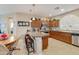 Well-appointed kitchen features stainless steel appliances, granite countertops, and breakfast bar seating at 4245 E Ficus Way, Gilbert, AZ 85298