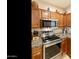 This stylish kitchen features stainless steel appliances, granite countertops, and ample cabinet space at 4245 E Ficus Way, Gilbert, AZ 85298