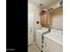 Efficient laundry room featuring a white washer and dryer, cabinetry, and a convenient utility sink at 4245 E Ficus Way, Gilbert, AZ 85298