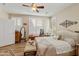 Bright main bedroom features plantation shutters, wood flooring, and a comfortable bench at 4245 E Ficus Way, Gilbert, AZ 85298
