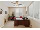 Inviting home office featuring wood flooring, plantation shutters, and a ceiling fan at 4245 E Ficus Way, Gilbert, AZ 85298