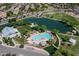 Aerial view of community pool, splashpad, park and lake at 4266 E Blue Sage Ct, Gilbert, AZ 85297
