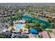 Community aerial view showcasing a lake, pool, playground, basketball court and a residential neighborhood at 4266 E Blue Sage Ct, Gilbert, AZ 85297