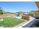 Spacious backyard boasts a pool, grassy area, and outdoor kitchen, providing an ideal setting for recreation and entertaining at 4266 E Blue Sage Ct, Gilbert, AZ 85297