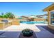 Well-designed backyard showcasing a pool, outdoor kitchen, and patio, creating an ideal space for relaxation and entertainment at 4266 E Blue Sage Ct, Gilbert, AZ 85297