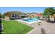 Beautifully landscaped backyard with a sparkling pool, patio area, and ample space for outdoor activities and relaxation at 4266 E Blue Sage Ct, Gilbert, AZ 85297