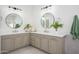 Bathroom with double sinks, modern fixtures, stylish mirrors, and patterned tile floor at 4266 E Blue Sage Ct, Gilbert, AZ 85297
