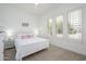Bright bedroom with white decor, large windows, and cozy carpet for a relaxing retreat at 4266 E Blue Sage Ct, Gilbert, AZ 85297