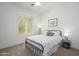 Cozy bedroom with a black metal bed frame, soft carpet, and a bright window for a restful ambiance at 4266 E Blue Sage Ct, Gilbert, AZ 85297