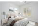 Bright bedroom featuring neutral decor, large window with shutter blinds, and plush bedding at 4266 E Blue Sage Ct, Gilbert, AZ 85297