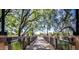 Scenic wooden bridge with black metal railings over calm lake surrounded by lush greenery at 4266 E Blue Sage Ct, Gilbert, AZ 85297