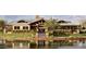 Exterior of a community clubhouse with pond view, landscape, and architectural detail at 4266 E Blue Sage Ct, Gilbert, AZ 85297