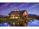 Community clubhouse with lake view, showing architecture, landscape and lighting at 4266 E Blue Sage Ct, Gilbert, AZ 85297