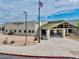 Exterior view of Centennial Elementary School with U.S. and Arizona flags on a sunny day at 4266 E Blue Sage Ct, Gilbert, AZ 85297