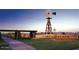 Grand entrance to Power Ranch with iconic windmill, stone features, and lush landscaping at 4266 E Blue Sage Ct, Gilbert, AZ 85297