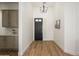 Inviting entryway featuring wood floors, modern chandelier, and gray cabinets creating an elegant welcome at 4266 E Blue Sage Ct, Gilbert, AZ 85297