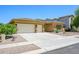Well-maintained single-story home with a large three-car garage and desert-style landscaping at 4266 E Blue Sage Ct, Gilbert, AZ 85297