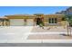 Charming single-story home featuring a three car garage, manicured landscaping, and a neutral color scheme at 4266 E Blue Sage Ct, Gilbert, AZ 85297