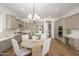 Well-lit open concept kitchen with a stylish dining table, stainless steel appliances, and neutral-colored cabinets at 4266 E Blue Sage Ct, Gilbert, AZ 85297