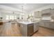 Open-concept kitchen with stainless steel appliances, a large island, and seamless flow to the living area at 4266 E Blue Sage Ct, Gilbert, AZ 85297