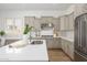 Contemporary kitchen with white countertops, stainless steel appliances, and stylish neutral-colored cabinets at 4266 E Blue Sage Ct, Gilbert, AZ 85297