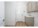 Functional laundry room featuring gray cabinets, a utility sink, and a clean, bright space at 4266 E Blue Sage Ct, Gilbert, AZ 85297
