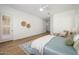 Bright main bedroom with wood floors, neutral decor, and lots of natural light shining through the windows at 4266 E Blue Sage Ct, Gilbert, AZ 85297