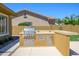Outdoor kitchen features a stainless steel grill, ample counter space, and storage, ideal for outdoor cooking and entertaining at 4266 E Blue Sage Ct, Gilbert, AZ 85297