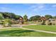 Community playground with swings, slides, climbing structures and covered picnic tables at 4266 E Blue Sage Ct, Gilbert, AZ 85297