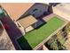 Aerial view of a home with a covered patio and artificial turf backyard at 43727 W Wade Dr, Maricopa, AZ 85138