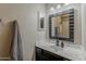 Bathroom with vanity and a dark framed mirror. A decorative hand towel adds to the decor at 43727 W Wade Dr, Maricopa, AZ 85138