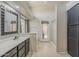 This bathroom features a double vanity, soaking tub, walk-in shower and access to the backyard at 43727 W Wade Dr, Maricopa, AZ 85138