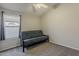 Cozy bedroom with carpeted floor, futon and a window with privacy blinds at 43727 W Wade Dr, Maricopa, AZ 85138