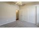 A bright bedroom with closet storage and a ceiling fan at 43727 W Wade Dr, Maricopa, AZ 85138