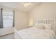 Bright bedroom with vaulted ceilings, carpet flooring, and a large window at 43727 W Wade Dr, Maricopa, AZ 85138