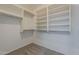 Well-organized walk-in closet with built-in shelving and hanging rods for optimal storage at 43727 W Wade Dr, Maricopa, AZ 85138