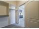 Open walk-in closet leading to a main bedroom, and bathroom, providing easy access at 43727 W Wade Dr, Maricopa, AZ 85138