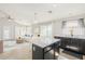 Modern kitchen with an island that connects seamlessly into a living area at 43727 W Wade Dr, Maricopa, AZ 85138