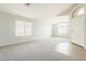 Spacious living room with carpet flooring, lots of natural light and a large window at 43727 W Wade Dr, Maricopa, AZ 85138