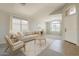 Bright living room features neutral decor, large windows, and stylish furnishings for comfortable living at 43727 W Wade Dr, Maricopa, AZ 85138