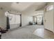 Open living room with neutral carpet, gray walls, and plentiful natural light from large windows at 43727 W Wade Dr, Maricopa, AZ 85138