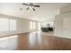 Open-concept living space offers beautiful hardwood flooring and recessed lighting at 43727 W Wade Dr, Maricopa, AZ 85138
