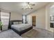 Spacious main bedroom with a plush bed, ceiling fan, and walk-in closet for ample storage at 43727 W Wade Dr, Maricopa, AZ 85138