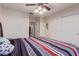 Cozy bedroom with ceiling fan, plush carpeting, closet, and view of closet in next room at 45539 W Long Way, Maricopa, AZ 85139