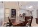 Dining area with a wooden table, chairs, and views into the open living space at 45539 W Long Way, Maricopa, AZ 85139